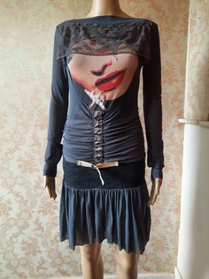 "Vintage punk style dress with a knitted dropped waistband. Grey stretchy fabric with a pink under skirt.  It has a lady's face on the bodice with a brown lace veil. A ruched middle with ornamental hooks and belt and a rara style skirt.  Very 80's.   Has some wear on the belt,  its very stretchy so would easily fit a size up. Bust;  33\" Waist;  30\" Length;  35\" Inside sleeve;   20\" Made by  PATRICIA FORGEAL" Halloween Fitted Mini Dress With Lace Trim, Fitted Mini Dress With Lace Trim For Halloween, Fitted Lace Mini Dress For Halloween, Fitted Corset Dress For Fall Costume Party, Fitted Gothic Mini Dress For Winter, Fitted Halloween Corset Dress With Lace Trim, Fitted Punk Dresses For Winter, Fitted Punk Winter Dresses, Fitted Long Sleeve Corset Dress For Halloween