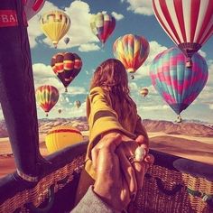 a person sitting in a hot air balloon with the words poshmark on it