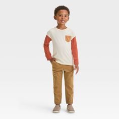 Whether you're getting them ready for preschool or taking them out on errands, keep your little one comfortable in these Woven Jogger Pants from Cat & Jack™. Designed in a relaxed-leg silhouette, these mid-rise jogger pants are crafted from midweight twill fabric for all-day cozy comfort. They're designed with reinforced knees, and they feature a full elastic waistband with a drawstring closure to help them find a secure fit. Showcasing a solid color and ribbed cuffs, they also have side and bac Casual Fall Playtime Bottoms, Casual Fall Bottoms For Playtime, Casual Pants For Playtime In Fall, Casual Pants For Fall Playtime, Casual Fall Playwear Bottoms, Cotton Pants For Playwear In Fall, Fall Cotton Playwear Pants, Fall Cotton Pants For Playwear, Fall Playwear Cotton Pants