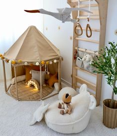 a child's bedroom with a teepee tent and stuffed animals