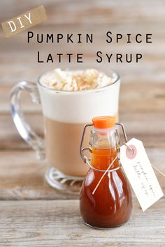 pumpkin spice latte syrup in a glass carafe next to a cup of coffee