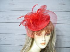 "Red fascinator with rosette center and matching biot feathers. You can wear this two ways, the veil in the front or turn it around for a different look. This is attached to a headband but I will include a clip so you can decide which you like best. Very light weight and easy to wear. Wear on either side of your head. Budget friendly. Love that! Size is about 11\" wide by 8\" tall. See other colors in my shop. Perfect for many events from weddings to Kentucky Derby.  I ship priority mail, it's more expensive but more reliable. Check out my other items in my shop https://www.etsy.com/shop/MsPurdy I ship many times a week. All sales are final. no exchanges or refunds. I accept paypal, credit cards and etsy gift cards. More items in my Etsy shop: https://www.etsy.com/shop/MsPurdy Internationa Garden Party Tea, Red Fascinator, Kentucky Derby Fascinator, Derby Fascinator, Ky Derby, Hat Wedding, Easter Hats, Tea Party Hats, Riding Hats