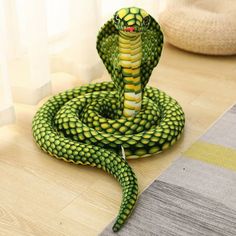 a green and yellow snake is on the floor