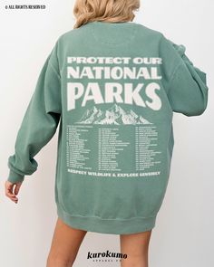 "This Unisex garment-dyed sweatshirt features \"Protect Our National Parks | Respect Wildlife & Explore Sensibly\" with a vintage mountain illustration and a complete list of all 63 National Parks in the U.S. on the back and a badge on the front pocket side. This sweater is perfect for raising awareness about the \"Leave No Trace\" principles when exploring the outdoors as well as being a unique U.S. National Park bucket list! » A B O U T « ‣ This item is made to order using direct-to-garment (D Oversized Graphic Print Sweatshirt For Outdoor, Outdoor Letter Print Sweatshirt For Spring, Spring Outdoor Sweatshirt With Letter Print, Oversized Letter Print Tops For Outdoor, Cotton Sweatshirt With Letter Print For Outdoor Activities, Cotton Sweatshirt With Letter Print For Outdoor, Cotton Letter Print Sweatshirt For Outdoor Activities, Spring Cotton Sweatshirt For Outdoor Activities, Cotton Sweatshirt For Spring Outdoor Activities