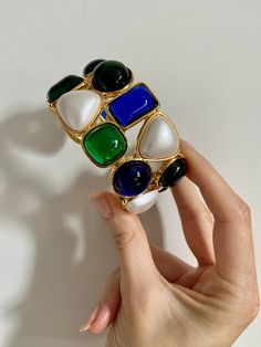 Giving serious Chanel vibes! These blue and green resin cuffs glow in the light! Set in luxe gold plate with matte pearl details. Absolutely stunning and chic to wear one on each arm! Perfect for your next holiday party. Contemporary - new condition.Internal diameter 2.5 inches x 2.25 inches. Price is for one cuff bracelet. Byzantine Jewelry, Pearl Cuff Bracelet, Pearl Cuff, Pearl Details, Woman Style, Gold Bracelet Cuff, Gold Cuffs, Gold Pearl, Blue And Green