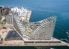 an aerial view of a large building next to the ocean