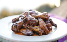 a white plate topped with meat covered in sauce