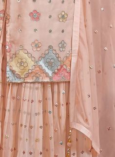 COLOR : Light Peach FABRIC : Top - Georgette, Bottom - Georgette, Dupatta - Georgette WORK : Resham Embroidery, Hand Work, Sequins, Motifs, Tassels, Lace Border OCCASION : Wedding, Reception, Party Wear, Festival READY-TO-WEAR : No STITCHING : Available as semi-stitched fabric, can be stitched using standard size option (+$20). Note: There might be a slight color variation due to lighting and flash used during photoshoot. The bright shade seen is the best closer view of fabric's color. Peach Sharara Suit, Peach Sharara, Embroidery Hand Work, Handwork Ideas, Wedding Reception Party, Resham Embroidery, Peach Fabric, Georgette Dupatta, Holiday Promotions