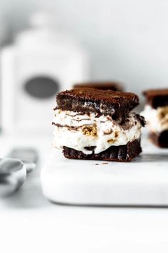 two ice cream sandwiches are on a cutting board