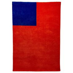 a red and blue rug is shown on a white background with the color block in it