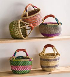 three baskets are sitting on the shelves with handles