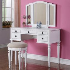 a white dressing table with mirror and stool