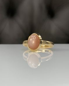 Natural Peach MoonStone * Dainty Cabachon Ring * Genuine MoonStone & 14K Solid Gold * Best Gift for her * Handmade Ring ◎ Details ◎ ○ Gemstone Details .Natural PEACH MOONSTONE Oval Cut 9X7 mm ○ Gold Details 14K Solid Gold Width of Band : 3.00 mm Weight of Ring : approx 4.60 gr Made to Order HANDMADE ITEM ○ Upgrade to Solid 18K Gold, please click the link below: https://www.etsy.com/listing/962826004 For more CABACHON BEZEL rings : http://etsy.me/37fvI60 All of our jewelleries are designed, c Elegant Domed Moonstone Gemstone Ring, Elegant Sunstone Jewelry, Round Shape, Classic Gold Moonstone Cabochon Ring, Classic Gold Moonstone Ring With Oval Cabochon, 14k Gold Moonstone Cabochon Ring For Anniversary, Elegant Untreated Moonstone Jewelry, Elegant Round Sunstone Jewelry, Elegant 14k Gold Cabochon Moonstone Ring, Elegant Oval Pink Opal Ring