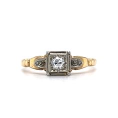 an antique diamond ring with two tone gold accents