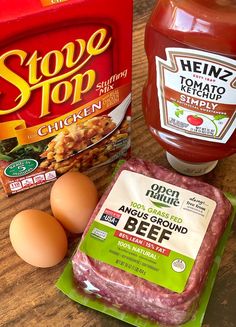 ingredients to make an entree laid out on a wooden counter top, including eggs, mayonnaise and ketchup