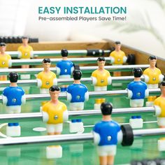 foosball table with many small figurines on it and the words easy installation pre - assembled players save time