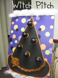 a witch hat made out of construction paper on top of a cardboard box with black and gold decorations