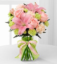 a vase filled with pink and green flowers