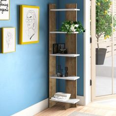 a room with blue walls and wooden shelves on the wall is filled with books, plants and pictures