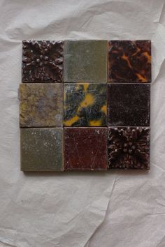 several different types of tile on a piece of white paper with brown and yellow designs