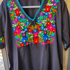 Cotton (?) Intricate Colorful Embroidery Sz Medium To Large. Labeled G. Imported From Mexico. Black V-neck Blouse With Floral Embroidery, Black Blouse With Intricate Embroidery For Festival, Traditional Black Embroidered Top For Spring, Black Tops With Intricate Embroidery For Festival, Black Top With Intricate Embroidery For Festival, Black Cotton Tops With Intricate Embroidery, Black Cotton Blouse With Geometric Embroidery, Black Floral Embroidery Festival Top, Black Embroidered Festival Tops