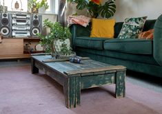 a living room filled with furniture and plants on top of a pink carpeted floor