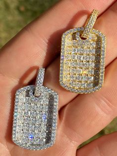 "Gorgeous hip hop dog tag pendant SUPER ICY! Solid 925 sterling silver We have 2 styles! Rhodium finished & 14k yellow gold finished! Measures roughly 1\" (1.5\" w. bale)...weighs roughly 12 grams 100 micropaved handset simulated diamonds (CZ) for a total of 4ct 100% 925 silver...not plated or filled...will NEVER TARNISH OR CHANGE COLOR Fits chains up to 5mm thick...our favorite look is with a dog tag moon chain You can buy pendant only or with choice of 18-30\" 2.5mm diamond cut ball moon c White Gold Dog Tag With Box Chain Jewelry, Silver Dog Tag Jewelry With Charms, Tarnish Resistant Silver Dog Tag Jewelry, Tarnish Resistant Silver Dog Tag, Moon Chain, Dog Tag Pendant, Color Fits, Diamond Ice, Gold Bond