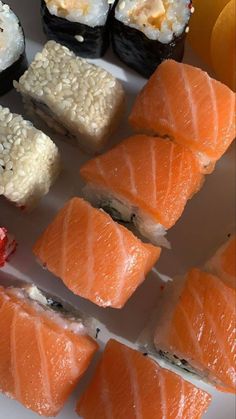 sushi is arranged on a white plate and ready to be eaten