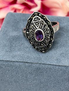 1930s Marcasite purple stone silver ring. It is Art Deco in style and has layers of marcasite which gives the ring layers. Nice Diamond Shape Ring. Stamped. It could do with polishing. I am a trusted vintage dealer based in the U.K. You can see by my reviews that I am always truthful in my descriptions of the vintage pieces I sell, so that you can buy with confidence. If you have any more questions about the piece, pease select the "Ask a Question" button next to the price and I will get back to Vintage Oval Marcasite Jewelry, Vintage Silver Amethyst Ring With Stone Setting, Vintage Marcasite Oval Rings, Vintage Oval Marcasite Rings, Vintage Oval Ring With Oxidized Finish, Vintage Amethyst Ring With Stone Setting, Vintage Marcasite Ring Stamped 925, Antique Silver Amethyst Ring, Vintage Silver Amethyst Ring With Accent Stones