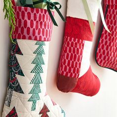 three christmas stockings hanging on the wall