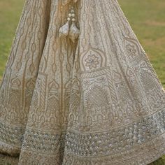 Featuring a nude gold raw silk lehenga set embroidered with traditional zardozi using gota patti, cutdana, sequins and dabka. Teamed with a matching embroidered blouse and a nude gold dupatta. An additional embroidered blush dupatta completes the bridal look. Composition: Lehenga and Blouse - Raw Silk, Dupatta- Net Care: Dry Clean Only and Vacuum Storage This product can be customised for colour, sleeves, length of blouse and neck design Delivery : 8-10 weeks as the product is hand crafted. For more information and sizes please contact fabiliciousfashion@gmail.com or visit our Copenhagen studio.About the Designer : Angad Singh's journey in the world of fashion started with at an early age as he grew up in a family business that was immersed in couture. Seeking to expand his knowledge, Anga Festive Sharara With Gold Embroidery, Raw Silk Lehenga With Mirror Work For Reception, Festive Anarkali Sharara With Gold Embroidery, Festive Chinon Sharara With Gold Embroidery, Anarkali Sharara With Gold Embroidery For Festive Occasions, Bollywood Style Raw Silk Sharara With Gold Embroidery, Festive Sharara With Gold Embroidery In Chinon, Traditional Raw Silk Lehenga With Gota Work, Festive Raw Silk Sharara With Gold Embroidery