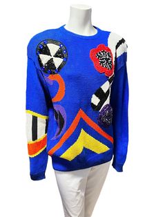 "Quintessential 80s dark navy blue knit sweater made from ramie cotton and cotton blend with 'wearable art\" stand out abstract motifs featured on the front. Crew neck and slightly oversize fit. With removable shoulder pads that are attached with velcro.  In great vintage condition, no flaws to note. Size Medium Measurements: 20\" pit to pit 28\" length 24\" sleeve" Retro Blue Knitted Sweater, Blue Retro Sweater With Graphic Print, Vintage Blue Knit Sweater, Retro Blue Knit Sweater, Blue Retro Knit Sweater, Navy Blue Knit Sweater, 80s Memories, Abstract Motifs, 80's Fashion