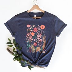 🎁 WELCOME TO OUR SHOP! Our graphic tees, sourced from the well-known brand BELLA+CANVAS, are both soft and trendy. They are long enough to wear with a pair of leggings, and soft enough to roll the sleeves, and if you want to add some flair, just tie it up in a knot. However you decide to wear it, you'll love the fit and comfort of this tee. 🛒 HOW TO ORDER 1️⃣ Select the shirt size & color. 2️⃣ Select the quantity. 3️⃣ Click "ADD TO CART". 4️⃣ You can go back to add more products for your loved ones. 5️⃣ You can now complete the checkout process. Please "Click Proceed to Check Out". 6️⃣ Finally, you have completed all the steps, and your product will be prepared to be shipped. ❗️ CARE INSTRUCTIONS To keep your new favorite tee looking and feeling great, follow these care tips: * Avoid usi Multicolor Crew Neck T-shirt With Plant Print, Pink Cotton T-shirt With Plant Print, Floral Graphic Tee With Screen Print, Botanical Graphic Print Cotton Shirt, Botanical Screen Print Cotton T-shirt, Botanical Flower Graphic Print T-shirt, Blue Floral Print Graphic Tee, Blue Graphic Tee With Floral Print, Botanical Style Flower Graphic T-shirt