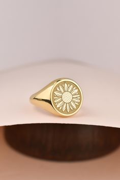 Welcome to LUXJ, Here you will find a beautiful selection of round signet rings with a variety of designs such as our Sunflower signet ring. Our team is happy to assist you with any questions you may have and we look forward to creating these special jewelry for you. *The images are taken from us and you will receive your ring as shown* | Information about the ring | - Face Size: 14x14mm - Band width at the bottom: 4mm | Material | - Sterling Silver 925 - Gold Vermail (925 base) - 9K Real Gold ( Personalized Gold Flower Ring, Elegant Yellow Gold Signet Ring For Gift, Sunflower Design Rings Suitable For Gifts, Anniversary Rings With Sunflower Design, Elegant Adjustable Yellow Gold Signet Ring, Hallmarked Yellow Gold Signet Ring, Symbolic Yellow Gold Hallmarked Signet Ring, Elegant Yellow Hallmarked Signet Ring, Signet Ring Gold