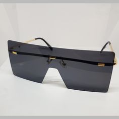 Stylish square rimless metal frame sunglasses. Black lenses and gold detail. Gold Rimless Shield Sunglasses With Polarized Lenses, Rimless Sunglasses, Safe Place, Sunglass Frames, Gold Details, Metal Frame, Metallica, Lenses, Sunglasses