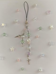 a cross hanging from the ceiling with beads and stars on it's back side