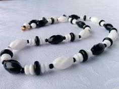 Beautiful milk glass and black glass beaded necklace from the 60's. It has oval ridged beads as well as disc and round shaped ones. The black and white colors make it such a timeless, retro piece of jewelry that will always be stylish to wear. All beads are clean and in excellent condition, necklace is in excellent condition. Necklace measures 18 inches, short, choker length. I'll ensure that your order is prepared as requested. Visit my shop at: newagainclassics.ca *Dec 7, 2021: Due to record b Garnet Jewelry, Garnet Ring Silver, White Milk Glass, Sterling Silver Garnet Ring, Necklace Black, Precious Stones Rings, Diamond Pendant Necklace, Glass Bead Necklace, Vintage Bracelets