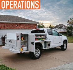 a white truck parked in front of a house with the words operation written on it