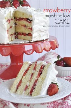 strawberry marshmallow cake with white frosting and fresh strawberries on the side