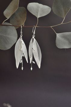 Shiny White leaf Earrings very light The leaves earrings are made of UV resin, each flower is fully created by hand. The jewelry is very light and delicate long-70mm They will add glimmer & radiance to your appearance ! The jewelry has been custom made, I can be re-designed as you wish. more earrings from the new collection https://www.etsy.com/shop/WingLine?ref=seller-platform-mcnav&section_id=22742307 Recommendation for use and care: * Don't clean with water and another liquid * Don't throw th Silver Leaf-shaped Earrings For Party, Handmade Leaf-shaped Wedding Jewelry, Elegant Leaf-shaped Wedding Jewelry, Nature-inspired Silver Flower Drop Earrings, Silver Sparkling Flower Earrings Gift, Silver Leaf-shaped Jewelry For Party, Handmade Leaf-shaped Jewelry For Wedding, Handmade Silver Flower Bridal Earrings, Handmade Leaf-shaped Wedding Earrings