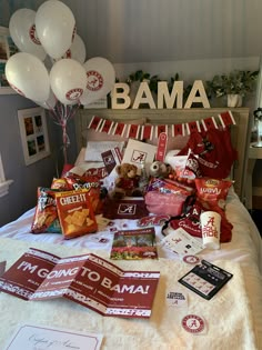 the bed has many items on it and is decorated with balloons in the shape of an obama sign