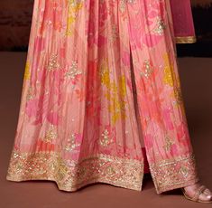 COLOR : Coral Pink FABRIC : Gown - Pure Georgette, Bottom - Mixed Fabric, Dupatta - Net WORK : Resham Embroidery, Zari Motifs, Floral Print, Sequins, Gota Patti, Lace BorderOCCASION : Wedding, Reception, Mehendi, Engagement, Party Wear, Festival READY-TO-WEAR : No STITCHING : Available as semi-stitched fabric, can be stitched using standard size option (+$20). Note: There might be a slight color variation due to lighting and flash used during photoshoot. The bright shade seen is the best closer Pink Anarkali Gown, Pink Anarkali, Resham Embroidery, Anarkali Gown, Net Dupatta, Color Coral, Lace Border, Pant Style, Pink Fabric