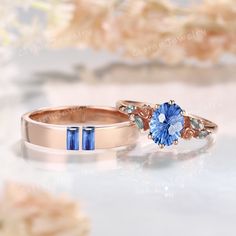 two wedding rings with blue stones on them