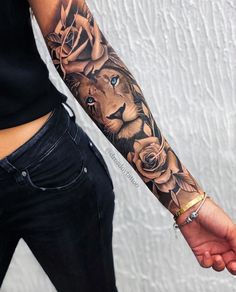 a man's arm with a lion and roses tattoo on it