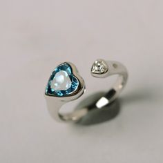 It is real London blue topaz ring, the heart cut topaz is about 8mm*8mm, weight about 2.33 carats. The basic metal is sterling silver and plated with rhodium. To change the metal to a solid gold (white/rose) or platinum is also available, please ask for a quotation if you want. You can also go to my shop Home for more elegant rings: https://www.etsy.com/shop/godjewelry?ref=hdr_shop_menu Topaz is November birthstone. More topaz rings: https://www.etsy.com/shop/godjewelry?ref=hdr_shop_menu&sec Silver Heart Rainbow Topaz Rings, Silver Heart Rainbow Topaz Heart Rings, Sterling Silver Open Heart Ring For Proposal, Sterling Silver Heart Cut Topaz Promise Ring, Heart-shaped Topaz Promise Ring, Silver Heart Ring With Birthstone For Proposal, Silver Heart Birthstone Ring For Proposal, Heart Shaped Silver Birthstone Ring For Proposal, Proposal Sterling Silver Heart Ring