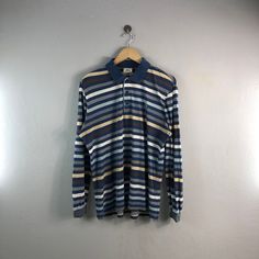 "PLEASE READ DESCRIPTION BELOW BEFORE BUYING👇🏻 *ITEM:Vintage lacoste polo shirt *ITEM DETAILS: 👇🏻 Please be aware that all vintage items will usually show a few signs of wear or fading due to age, but anything visible such as stains or holes, and serious flaws have been photographed.For any further information on this item please contact us and we will be happy to help *SIZE: LARGE *ACTUAL SIZE MEASUREMENT: 👇🏻 *PIT TO PIT(WIDTH):22\"INCHES *LENGTH(FROM SHOULDER): 28\"INCHES *ALL MEASUREMEN Fall Blue Cotton Polo Shirt, Fall Cotton Crew Neck Polo Shirt, Blue Polo Shirt With Relaxed Fit And Crew Neck, Blue Relaxed Fit Polo Shirt With Crew Neck, Vintage Blue Collared T-shirt, Navy Retro Long Sleeve Top, Retro Long Sleeve Navy Top, Navy Long Sleeve Retro Tops, Casual Striped Long Sleeve Polo Shirt