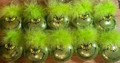 there are many green eggs with yellow eyes and fluffy furs on them, all lined up in a row