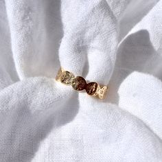 This boho inspired hammered coin ring is the perfect everyday essential ring. Made of 18k gold plated material, it is durable enough for swimming, sweating, and showering. The ring is easily adjustable (it is open in the back). Gently pull the sides to adjust to practically any ring size you desire! Adjustable Round Midi Rings In Recycled Gold, Adjustable Recycled Gold Midi Rings, Adjustable Yellow Gold Midi Rings, Adjustable Hammered Gold Ring, Adjustable Gold Hammered Ring, Adjustable Hammered Brass Ring, Adjustable Dainty Hammered Midi Rings, Adjustable Hammered Midi Rings, Adjustable Yellow Gold Plated Midi Rings