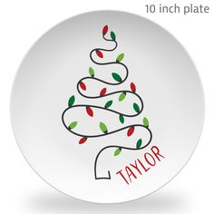 a white plate with a christmas tree on the front and name taylor written in red