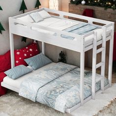 a white bunk bed sitting next to a christmas tree